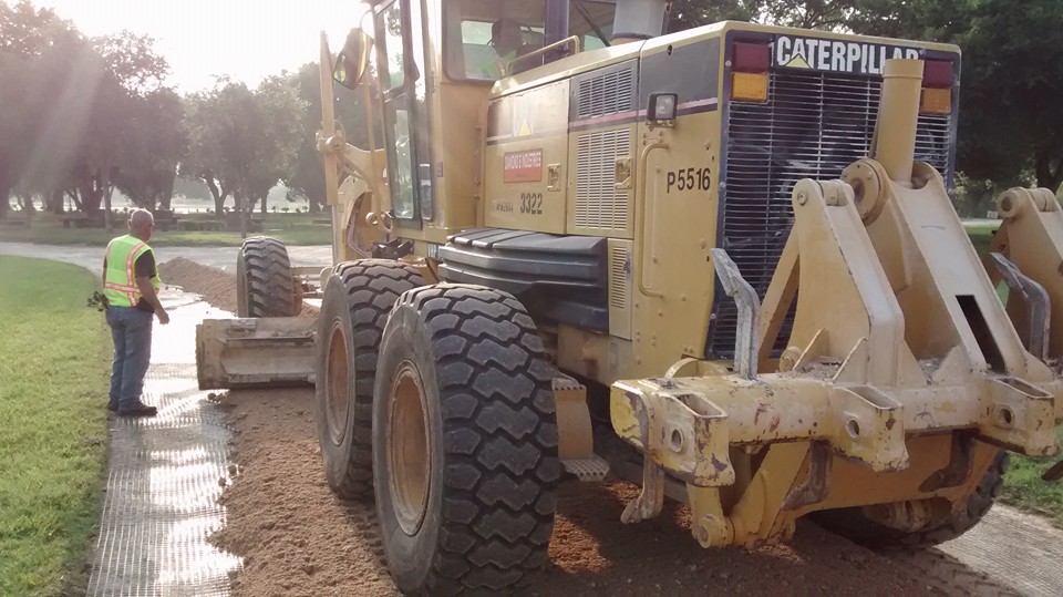 Diamond Eight CAT motor grader on geogrid — South Texas